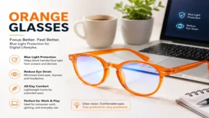 Orange glasses with blue light blocking lenses placed beside a laptop workspace