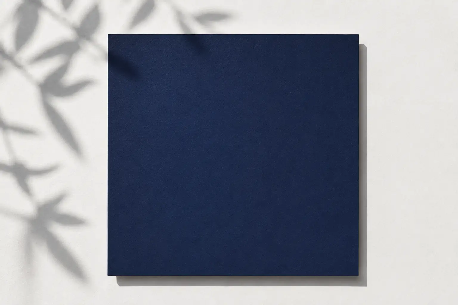 Navy blue color block on a clean light background with natural shadows